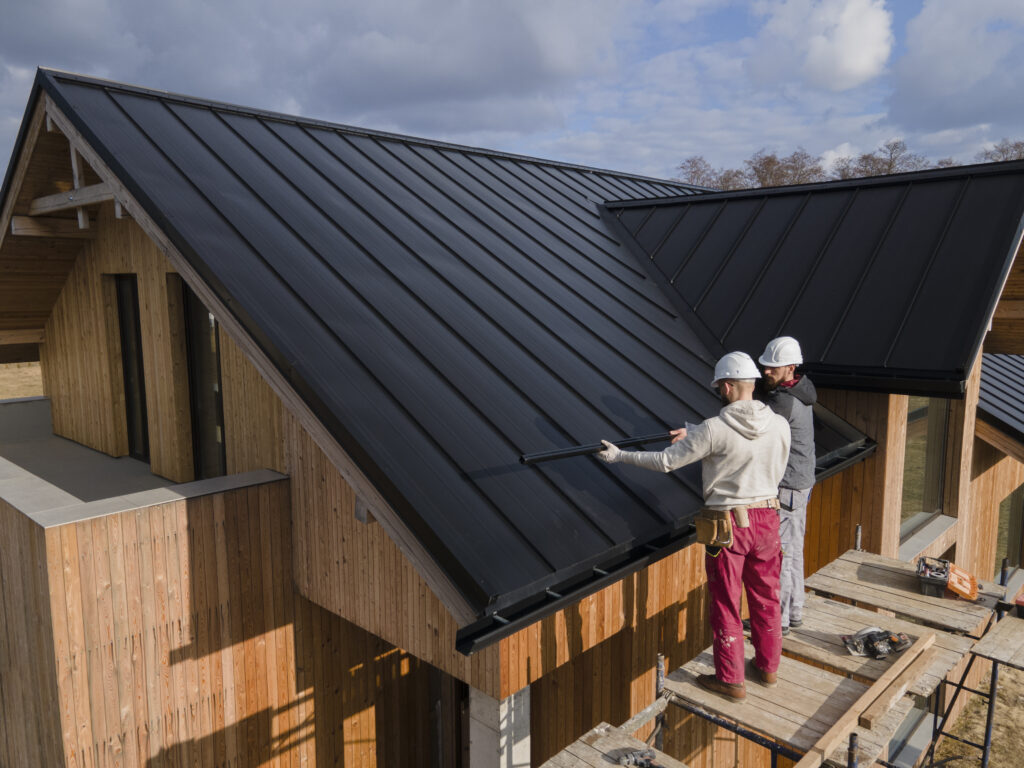 What Homeowners Should Know About GAF Roofing and Working with Exterior Source of Central Virginia 2 Two roofers working on a metal roof installation